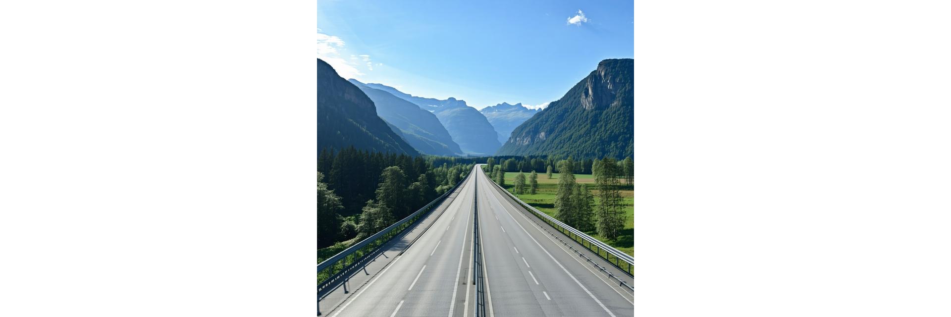 Scenic view of an Austrian autobahn winding through mountains with a clear blue sky